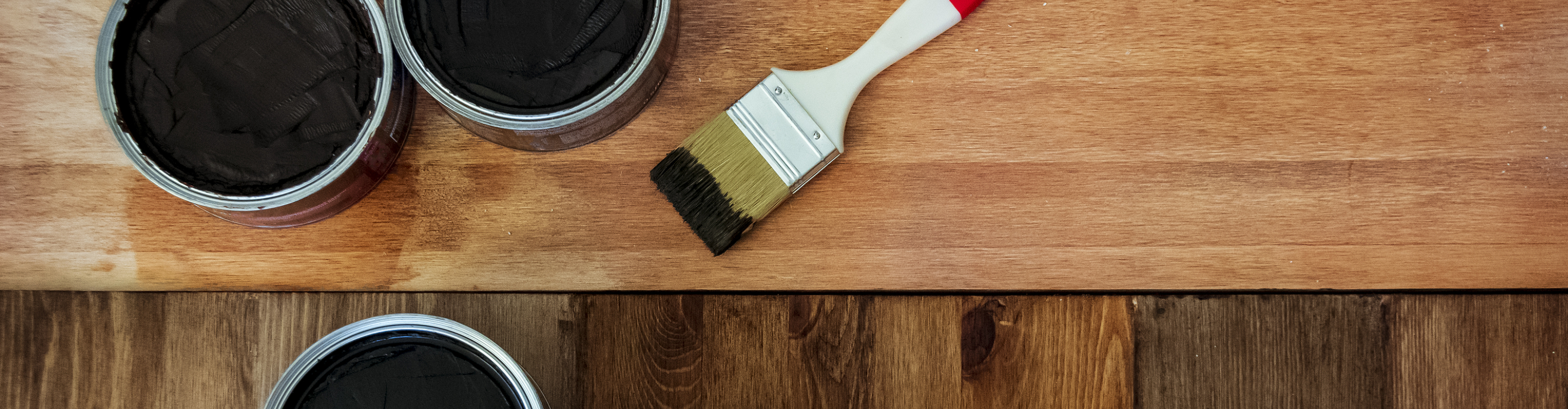 Closeup of hardwood floor and stain/brush